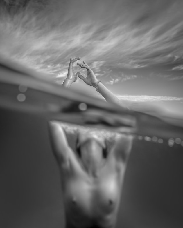 People category winner, Craig Stampfli, Reaching Out. Craig Stampfli's image was a collaboration with NSW model Joanne, and was captured in Ocean shores, just north of Byron Bay. 
“The intention with this image was to capture her hands as they escaped the surface,” he says. 
“I wanted her hands to be sharp and defined, with less focus on her physique. The added bonus with this split image was that her face was obscured by the water’s edge. Although Joanne is a remarkably beautiful woman, I have been working on a series of underwater portraits where the subject’s face is obscured.”