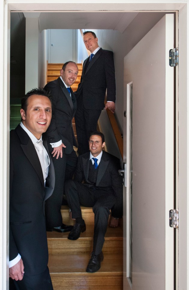 This front door and stairway of a house, along with some soft lighting provided nice setting for this portrait of the groom and his groomsmen.